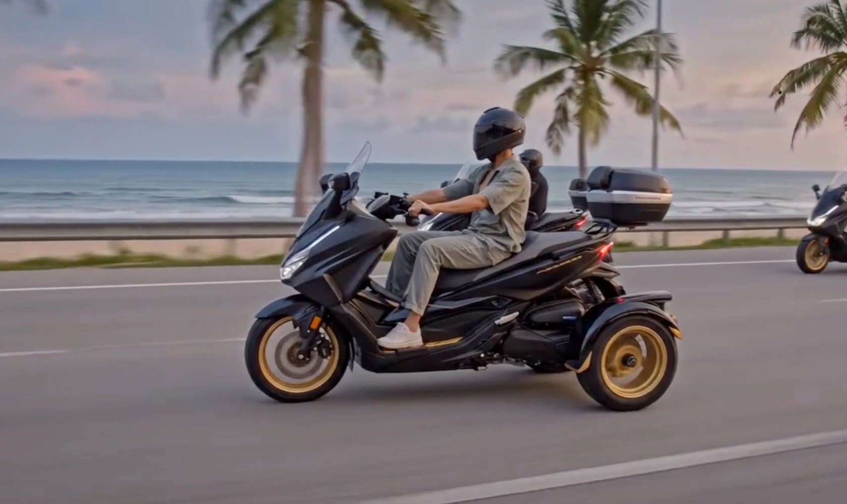 Ozimoto three-wheel motorcycle being ridden along the Hua Hin coast
